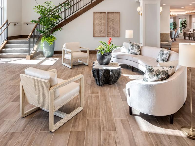 sitting area with two chairs and a long, curved couch in communal space at amavida