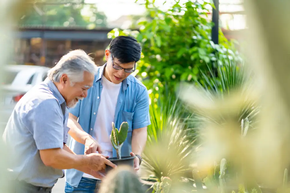 a man gardening with his senior father with dementia
