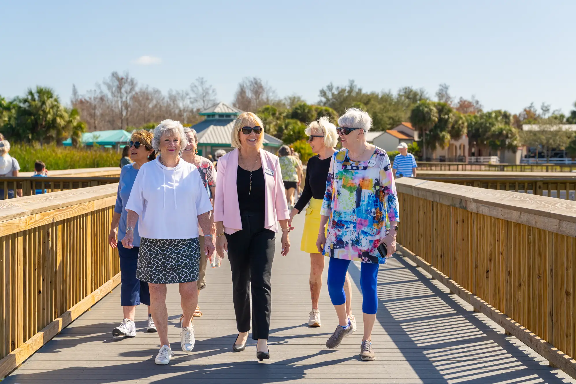 A group of elderly women walking on bridge that found senior companionship at Amavida in Fort Myers, Florida