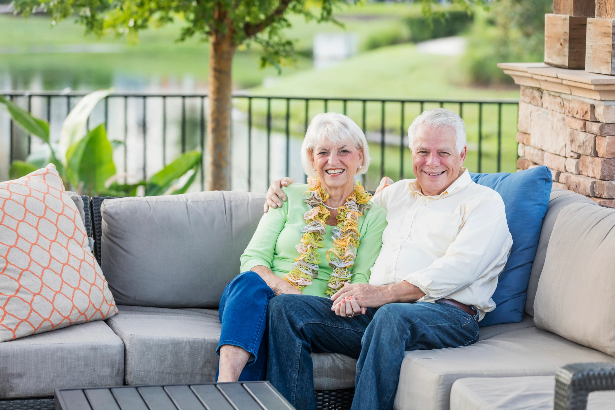 An image of a a senior couple sitting together on a couch while exploring how Amavida provides 10 Ways Independent Living Boosts Your Health in Retirement.