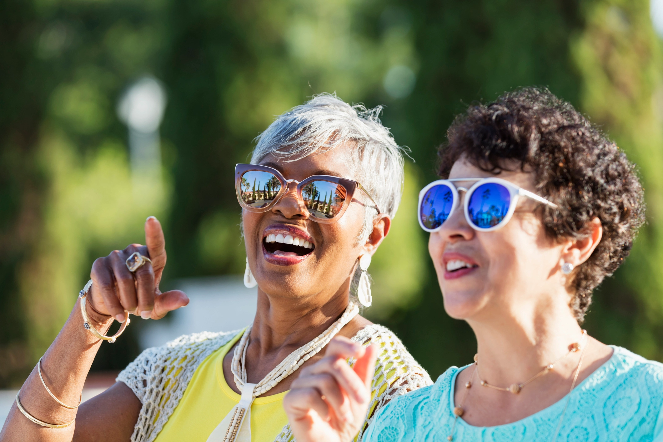 2 elderly women with glasses smiling outside of Amavida in Fort Myers, FL.